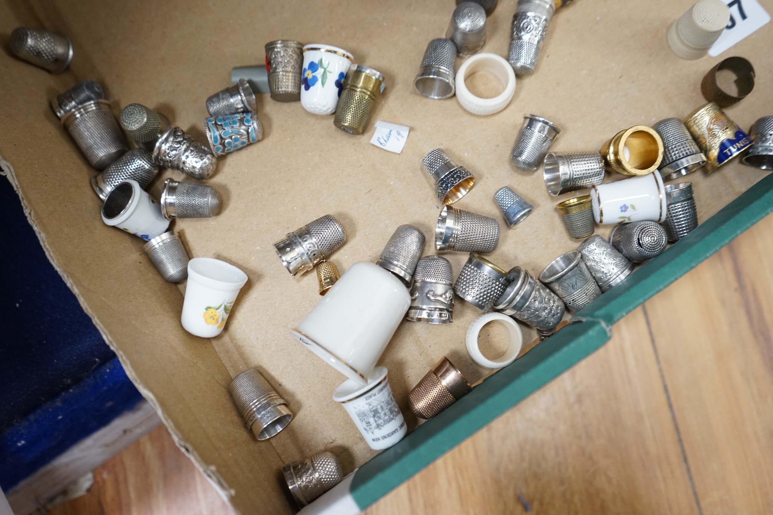 A large collection of silver, nickel, brass and ceramic thimbles, and two thimble display perspex domes. Condition - fair